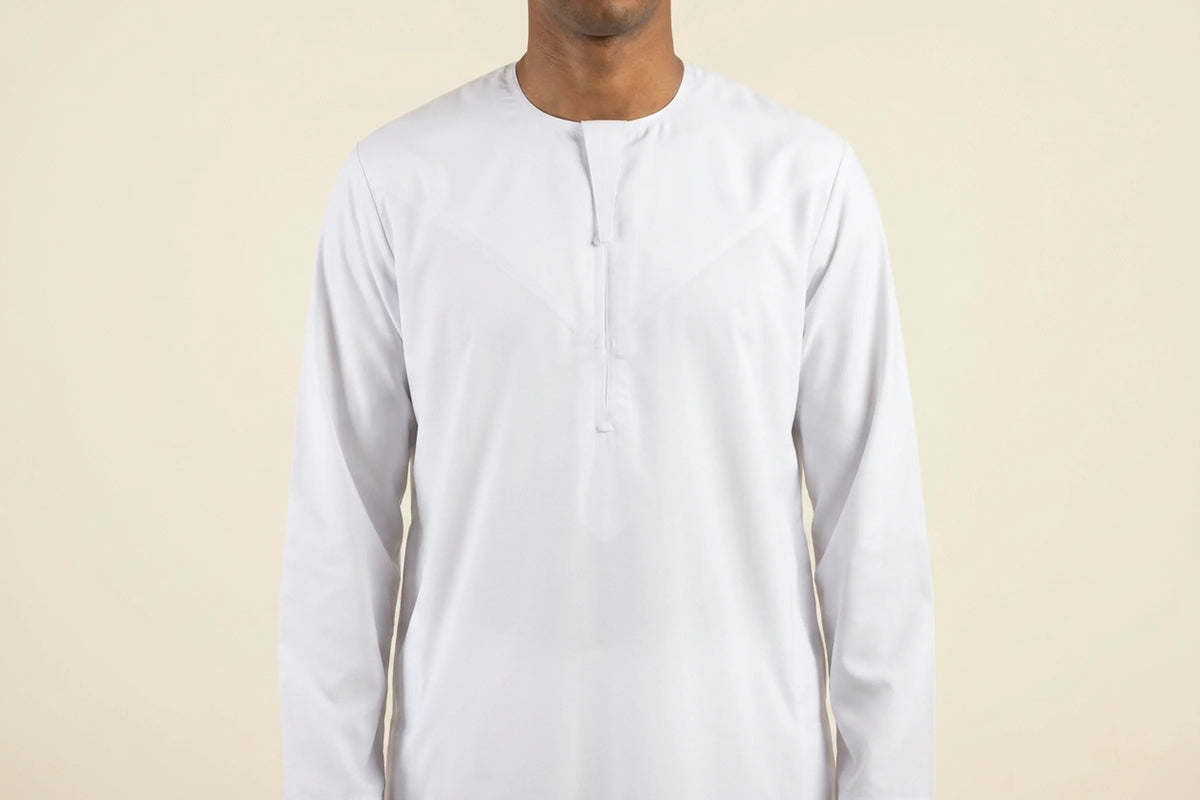 Qamis blanc porté, encolure ronde sans col et empiècement en V sur la poitrine