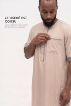 Le liséré gris du qamis Issa beige, sur la poche poitrine et la patte de boutonnage