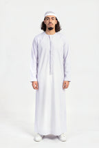 Qamis omani blanc Hamza porté de face, encolure ronde sans col et tarboucha tressée ton sur ton